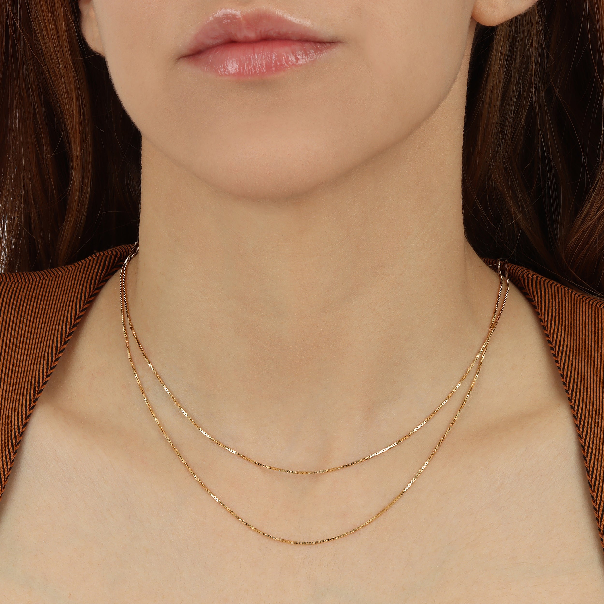 A model wearing 0.9mm Classic  Box Chain in Solid 14K Gold Yellow and also available in 18k 16 inch and 18 inch stacked together with a detailed product shot