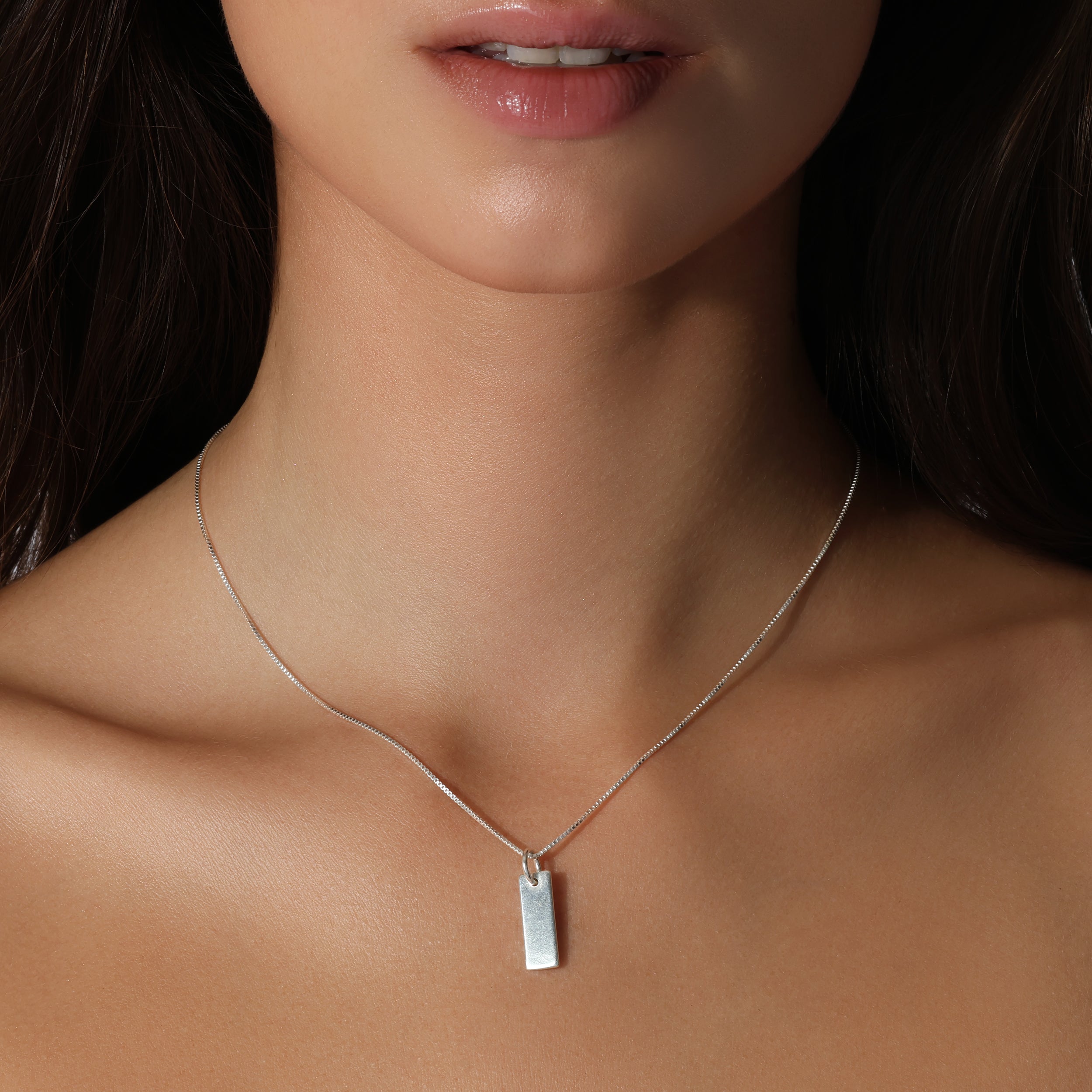 lady model wearing sterling silver chain with solid 925 dog tag plate charm pendant hanging