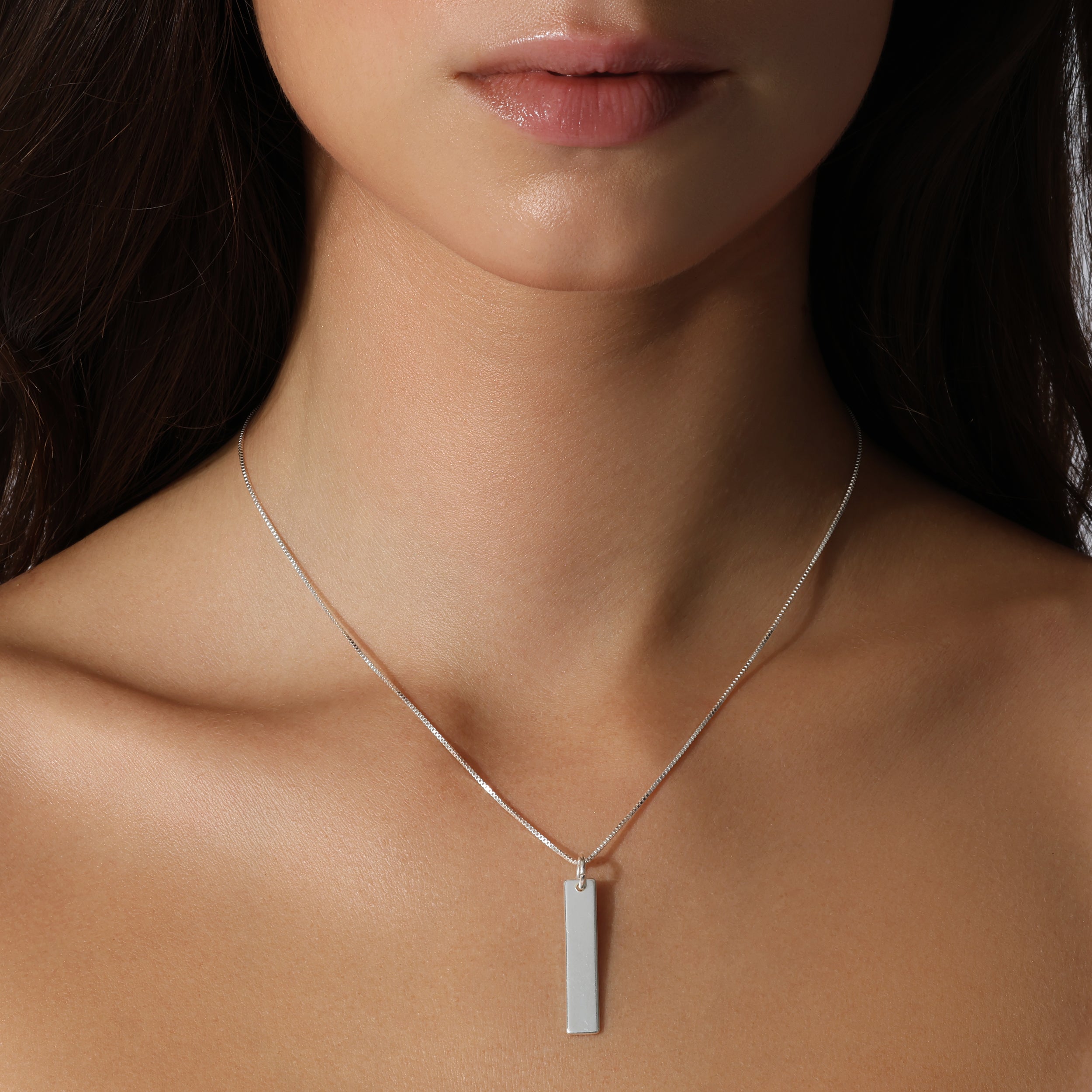 lady model wearing sterling silver chain with solid 925 dog tag plate charm pendant hanging